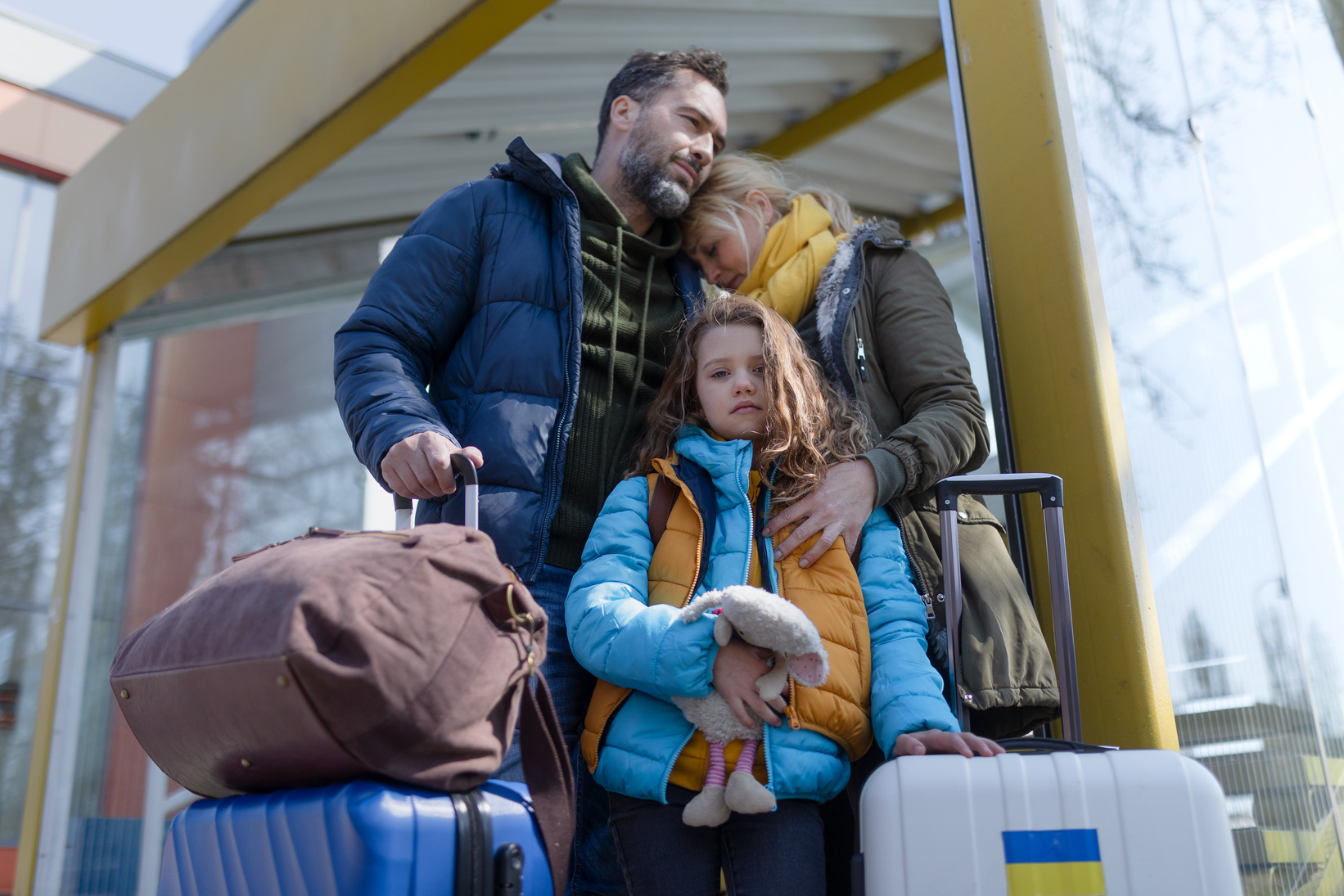 Ukrainian Refugee  with Luggage at Railway Station Together, Ukrainian War Concept.